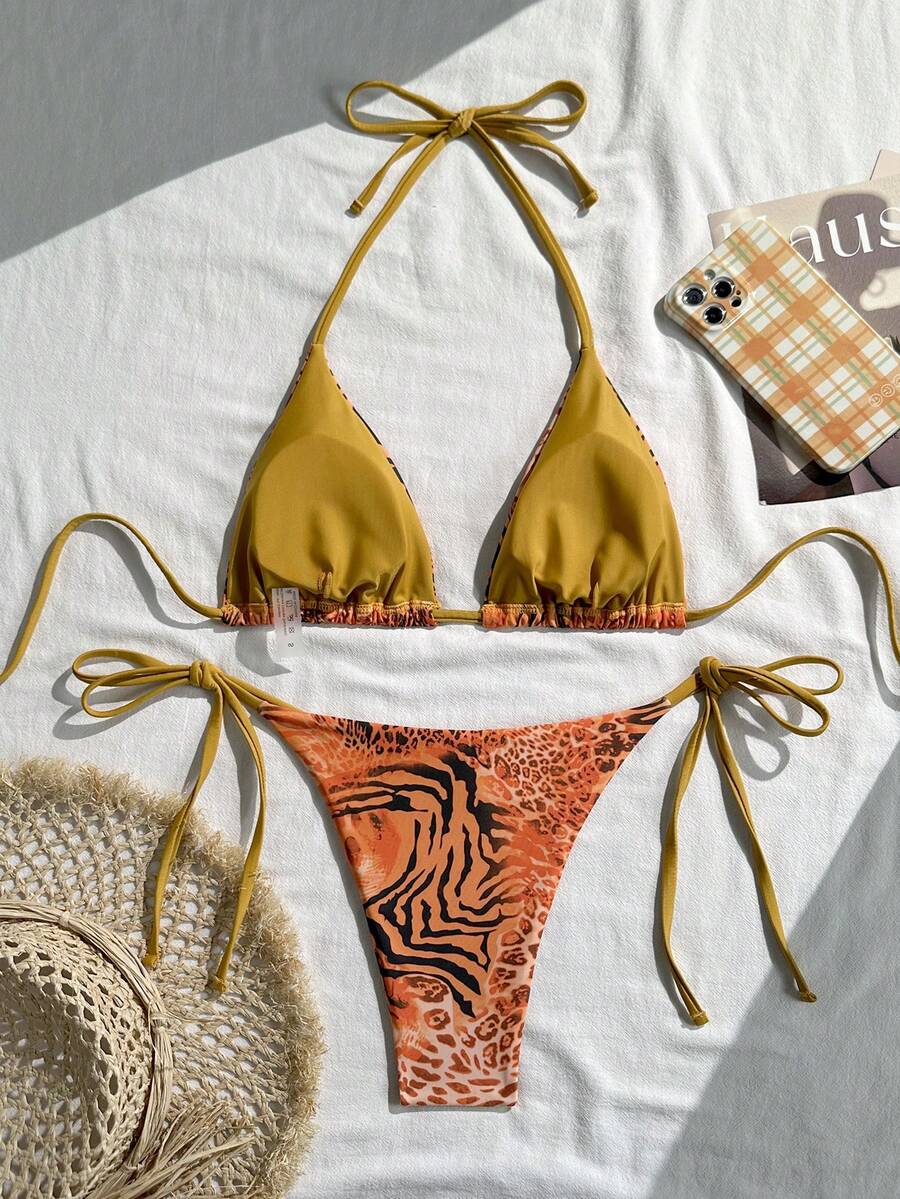 Women's vintage leopard print 2-piece bikini set featuring a high waist tie-side bottom and a halter neck triangle top.