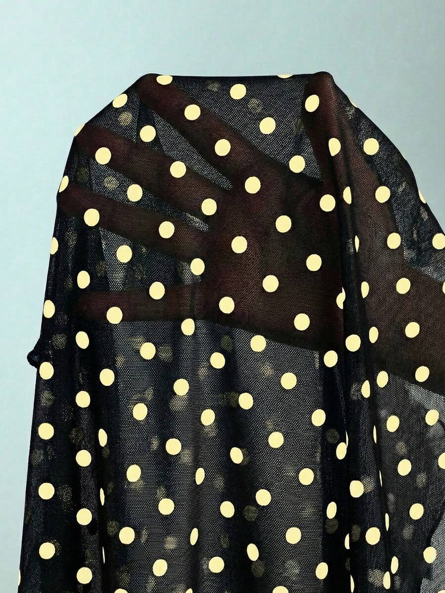 Women's apricot polka dot two-piece swimsuit featuring an asymmetrical halter backless top with knot tie detail and high-waisted bottoms.