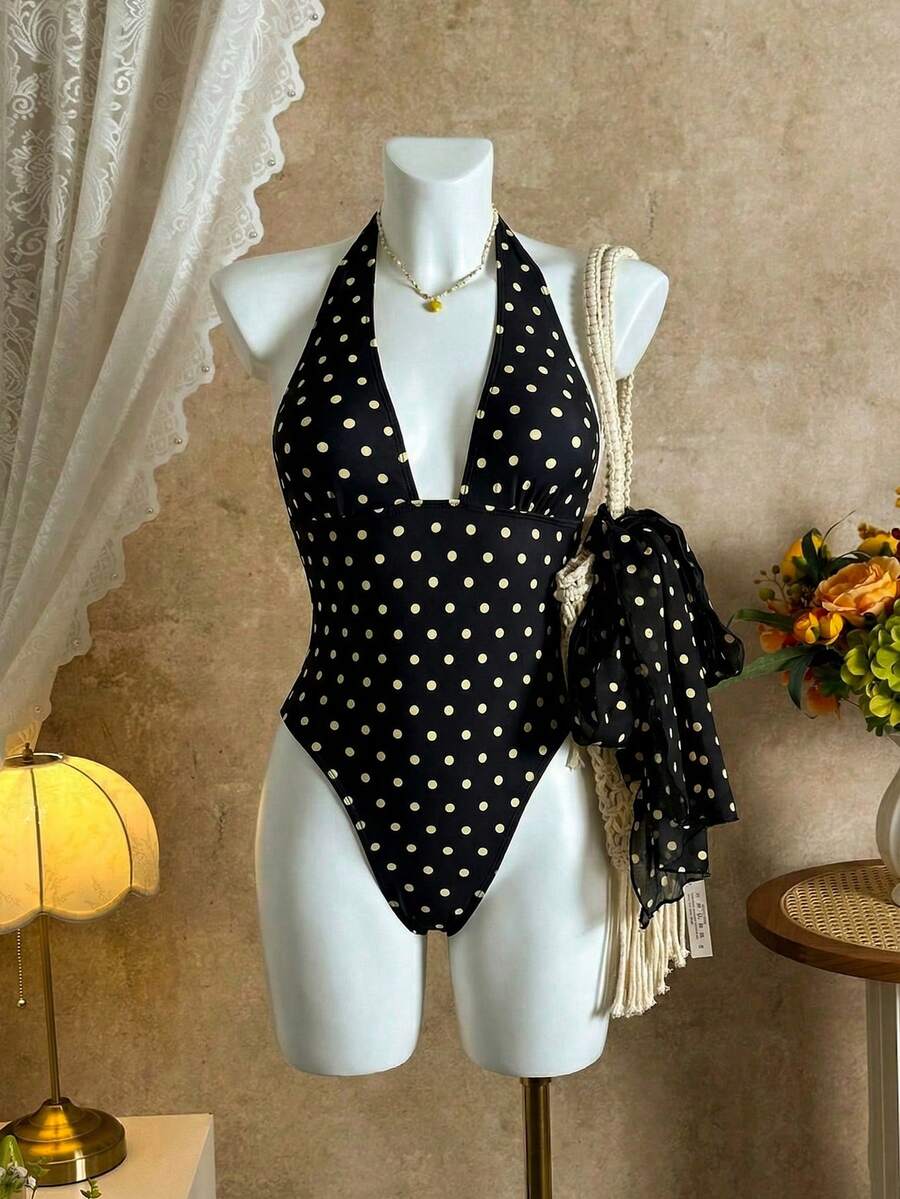 Women's apricot polka dot two-piece swimsuit featuring an asymmetrical halter backless top with knot tie detail and high-waisted bottoms.