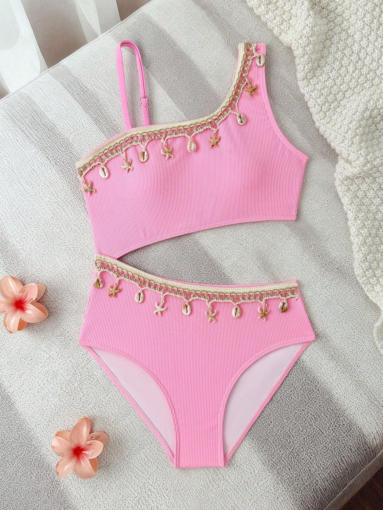 Girls black one-piece swimsuit with asymmetrical neckline, cutout waist detail, colorblock design, and medium-stretch swimsuit fabric for beach and pool wear.