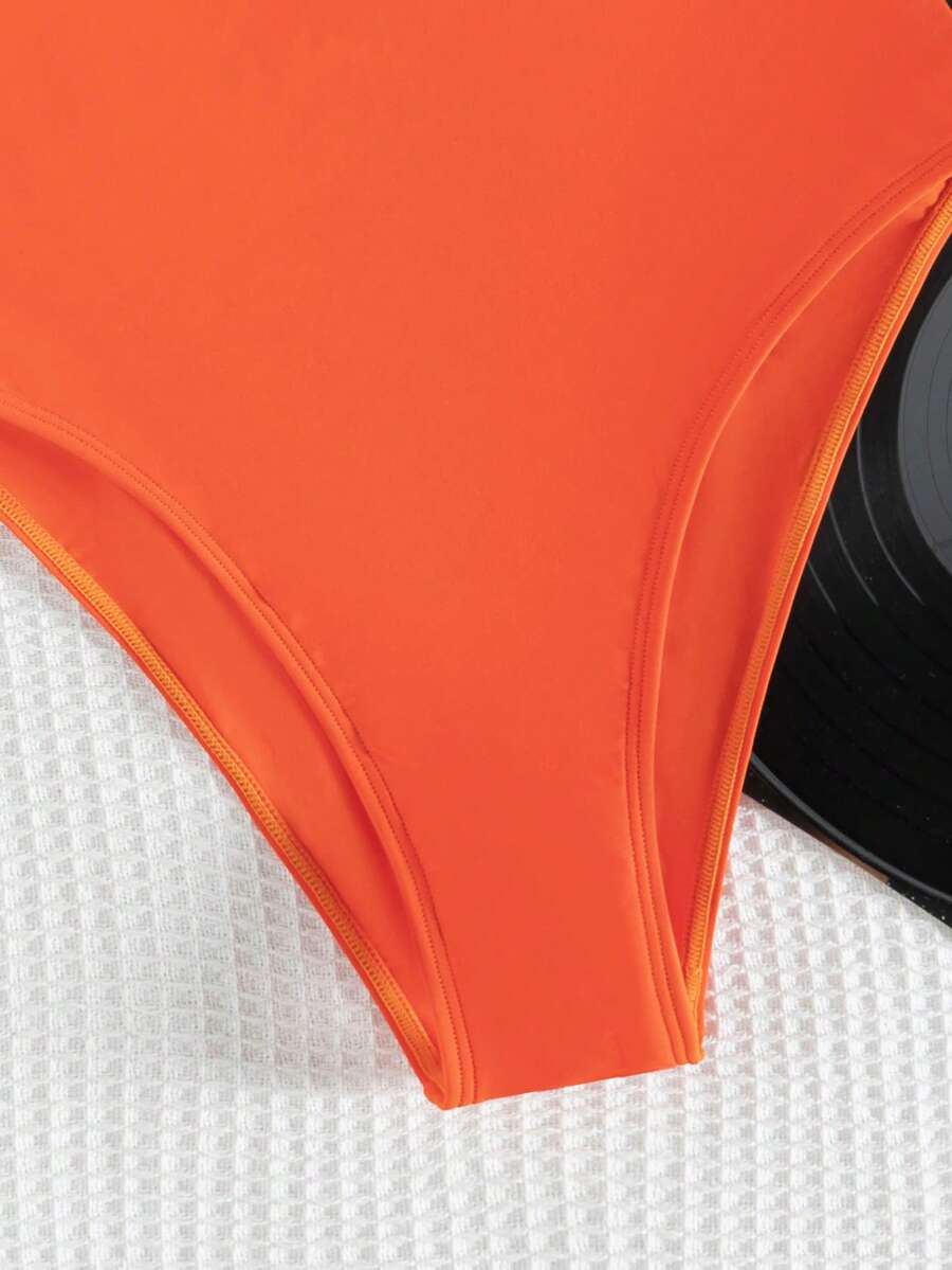 Women's solid color one-piece swimsuit featuring a backless scoop neck design and high cut fit
