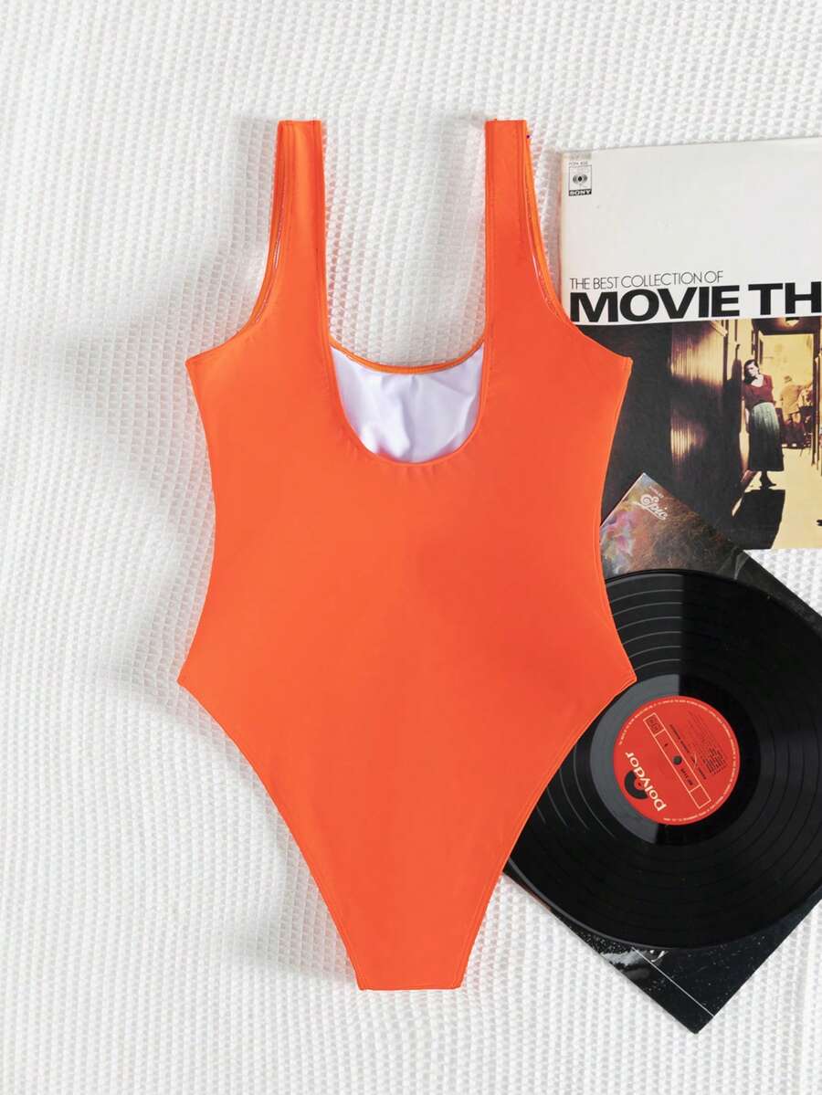 Women's solid color one-piece swimsuit featuring a backless scoop neck design and high cut fit