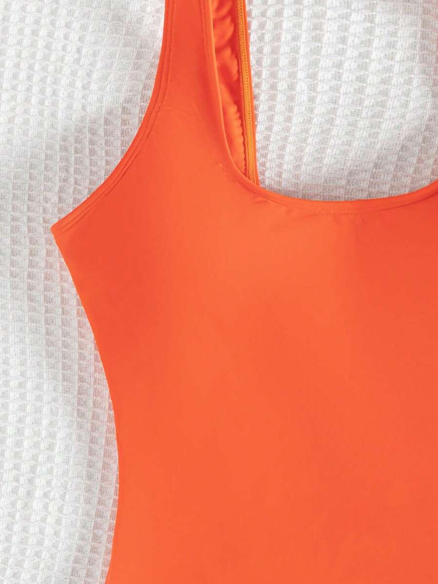 Women's solid color one-piece swimsuit featuring a backless scoop neck design and high cut fit