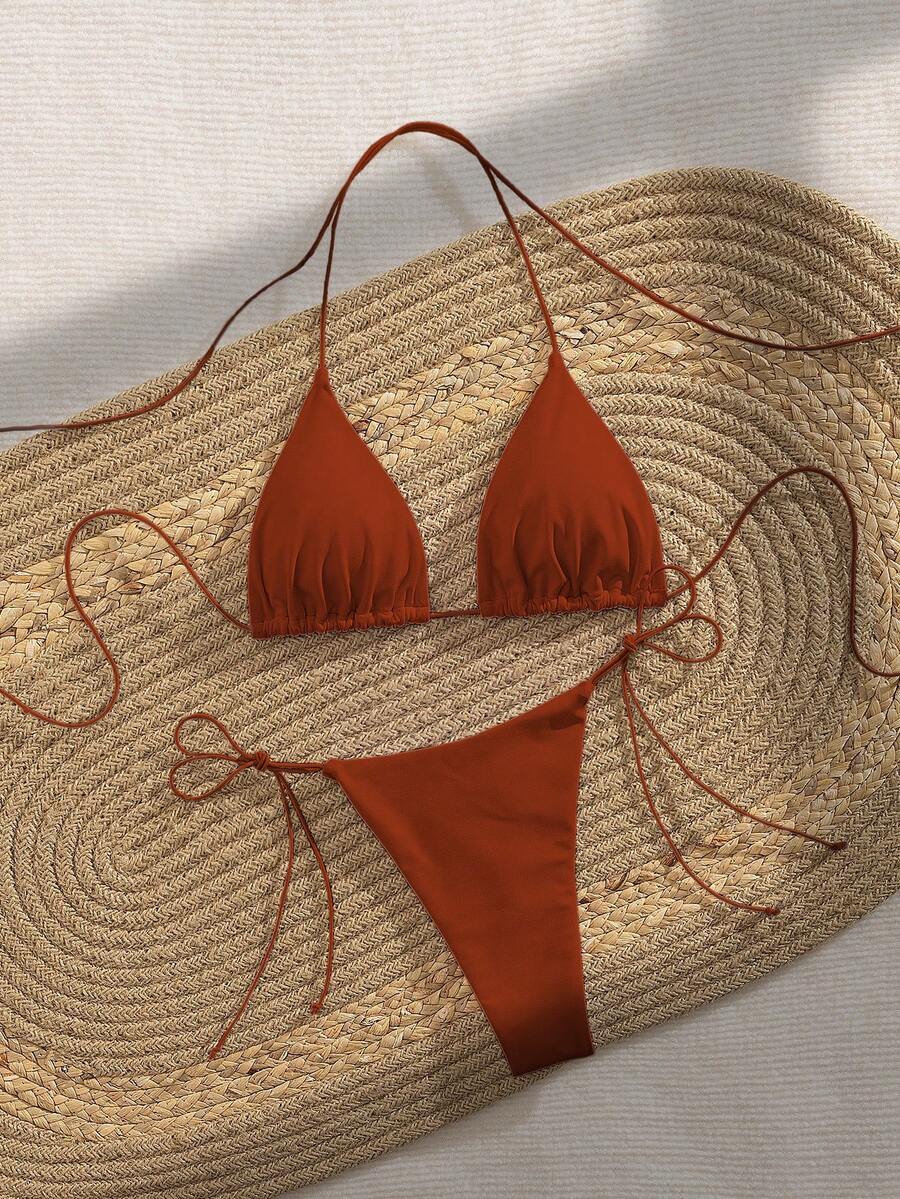 Women's 2-piece bikini set featuring a backless halter triangle top and tie-side ultra low waist bottoms.