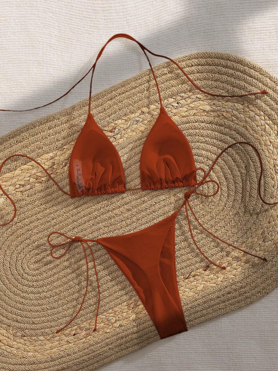 Women's 2-piece bikini set featuring a backless halter triangle top and tie-side ultra low waist bottoms.