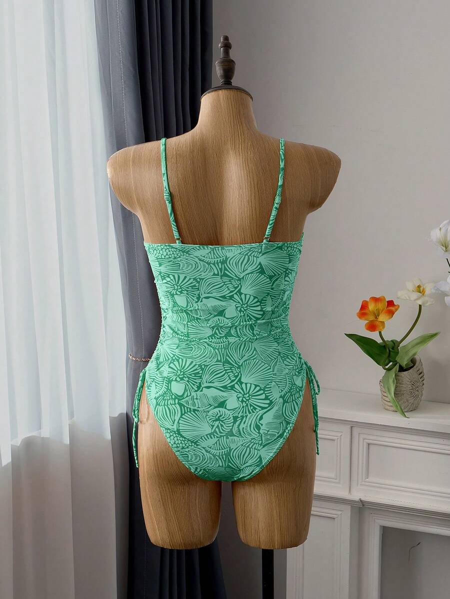 Women's blue backless one-piece swimsuit featuring spaghetti straps, wireless bra with removable padding, and drawstring details.