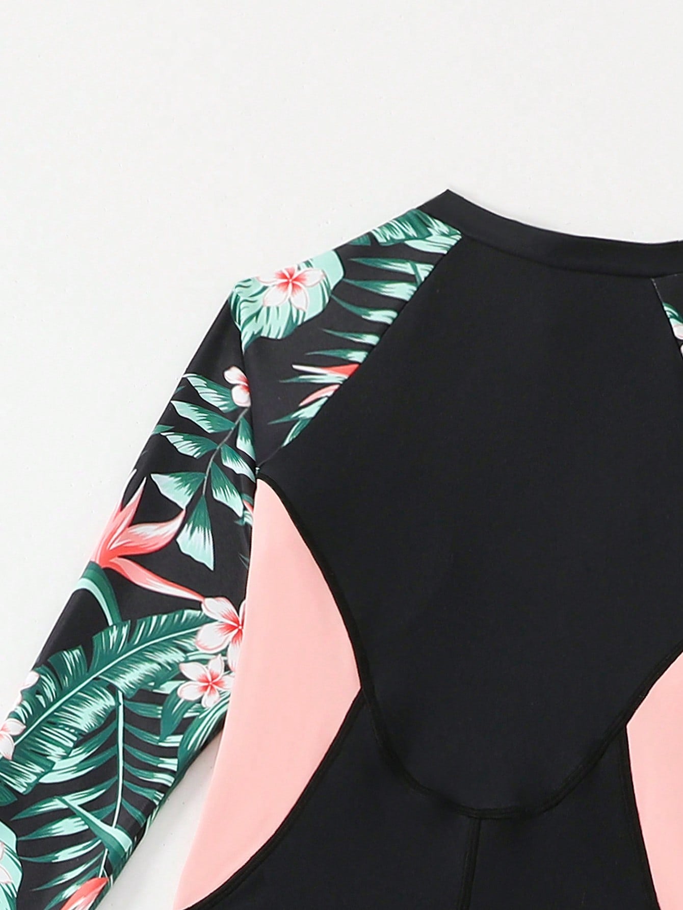 Tween girls black one-piece swimsuit with long sleeves, high neck, zipper detail, graphic leopard heart print, and fitted full-coverage swimwear style.