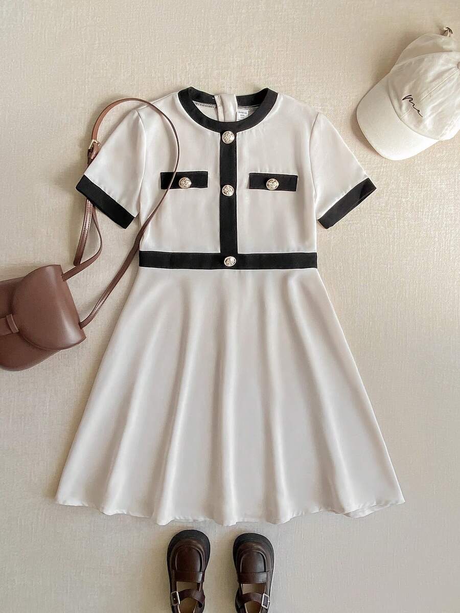 Nova Glow tween girls black and white houndstooth print short sleeve A-line dress with decorative buttons and crew neckline.