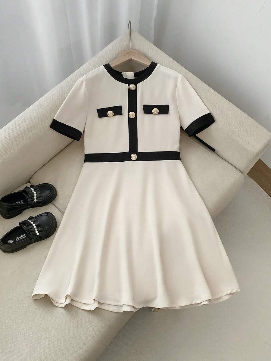 Nova Glow tween girls black and white houndstooth print short sleeve A-line dress with decorative buttons and crew neckline.
