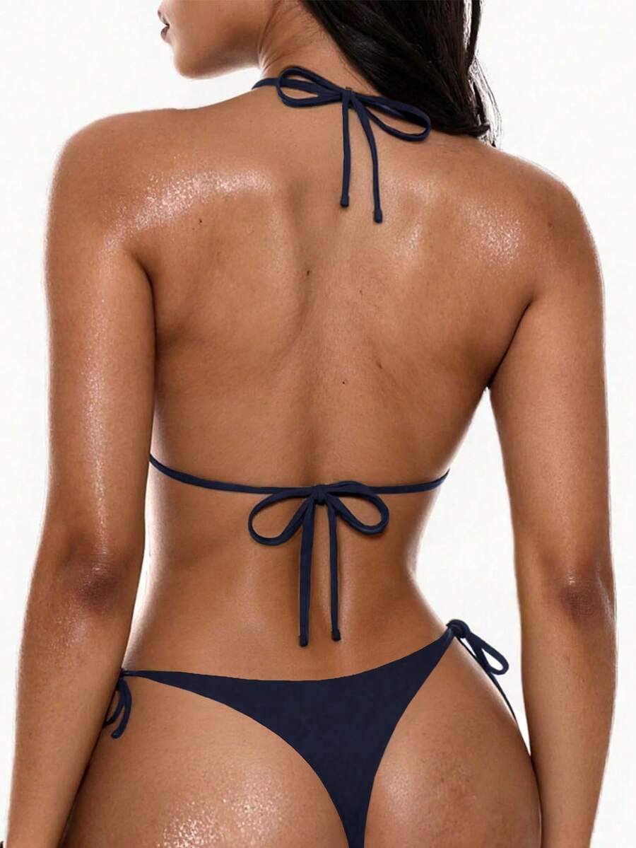 Women's halter neck bikini swimwear set featuring a wireless backless top and low-waist tie-side thong bottoms.