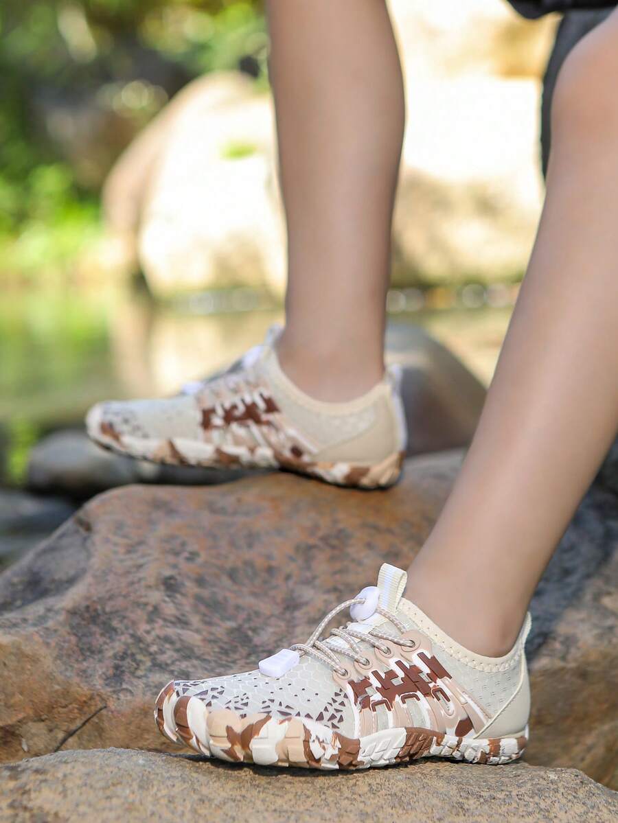 Apricot children's water shoes featuring slip-on fabric uppers, drawstring details, and rubber soles for beach play.