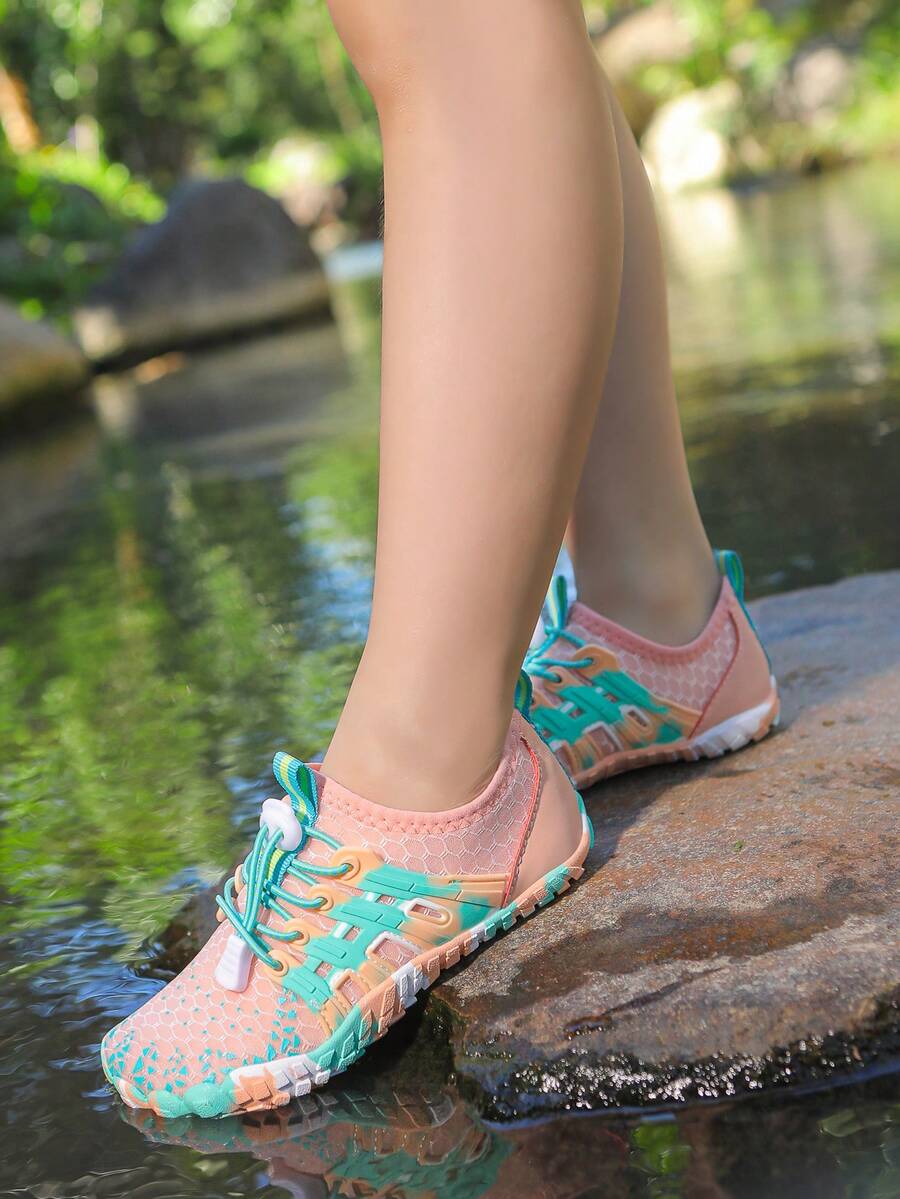 Apricot children's water shoes featuring slip-on fabric uppers, drawstring details, and rubber soles for beach play.