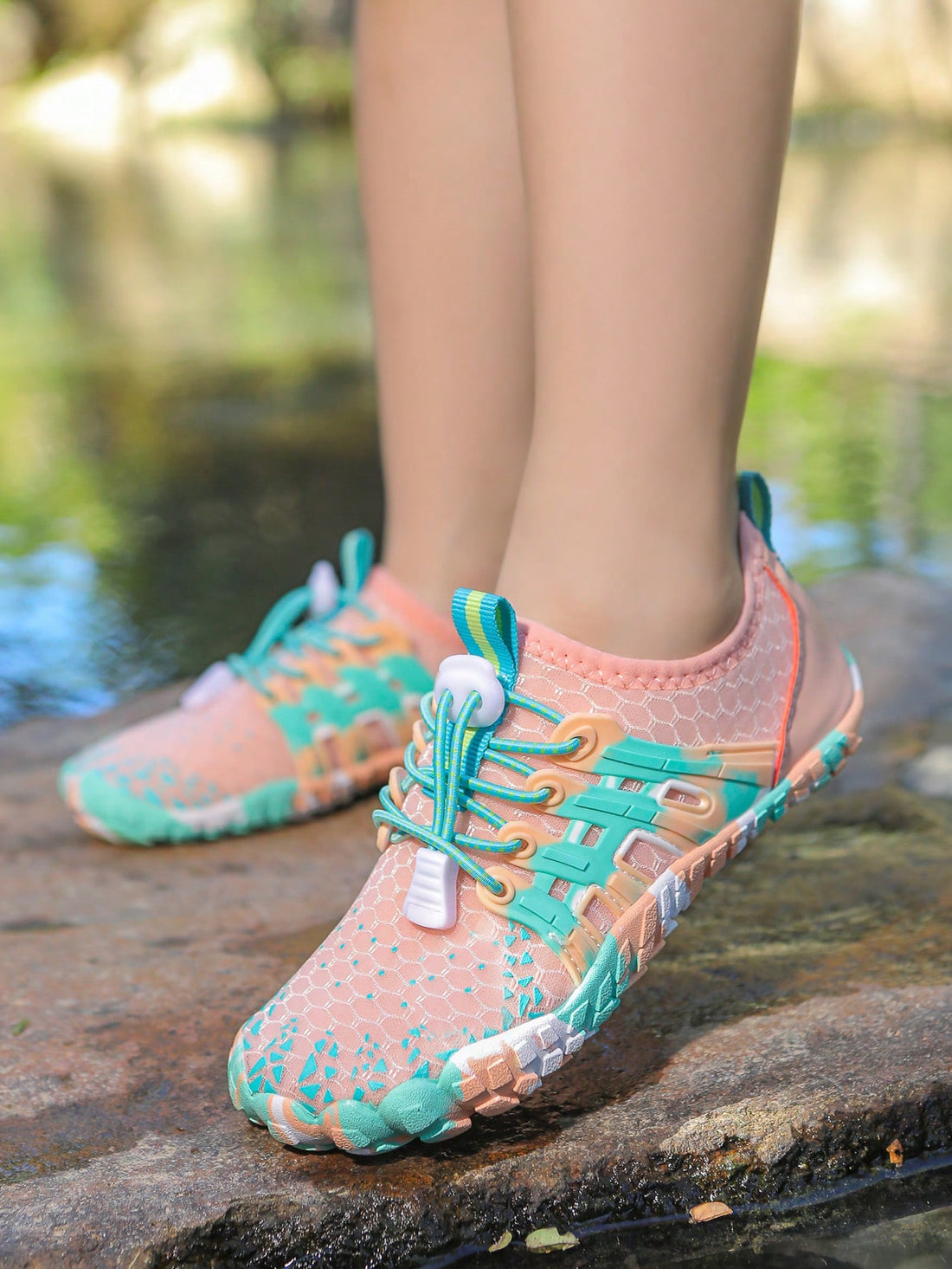 Apricot children's water shoes featuring slip-on fabric uppers, drawstring details, and rubber soles for beach play.