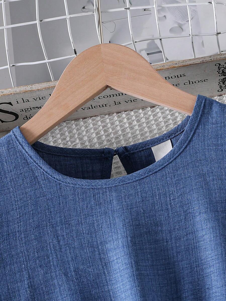 Tween girls dusty blue casual A-line dress with round neck, ruffle accents, high waist, and flared hem.