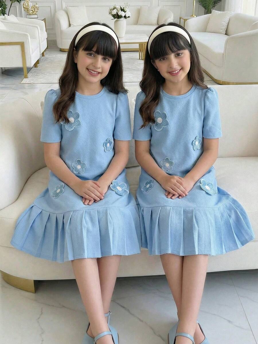Tween girls apricot short-sleeve pleated smock dress with 3D bow decor and round neckline.