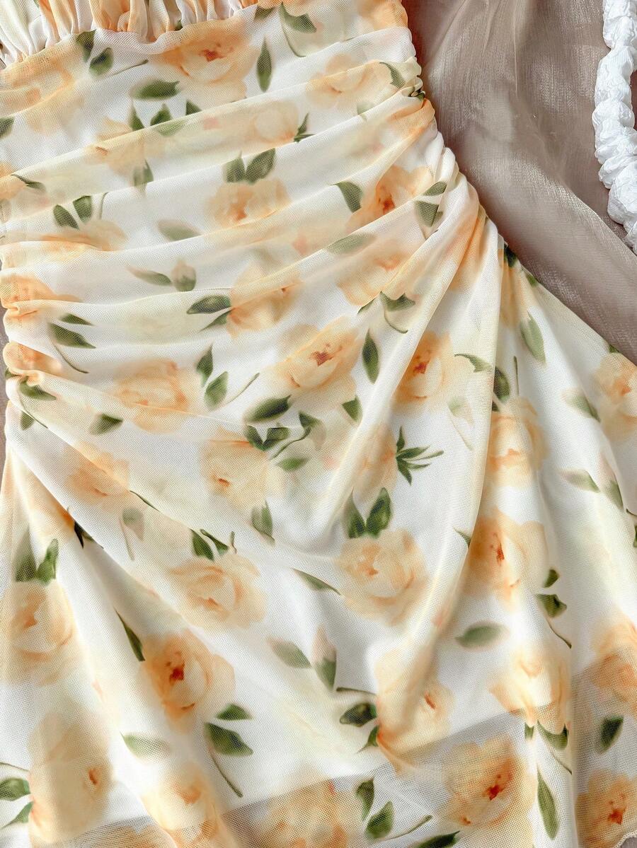 Tween girl yellow mini sundress with large pink floral hibiscus print, spaghetti straps, high waist, flared hem, and sleeveless cami style for summer beach wear