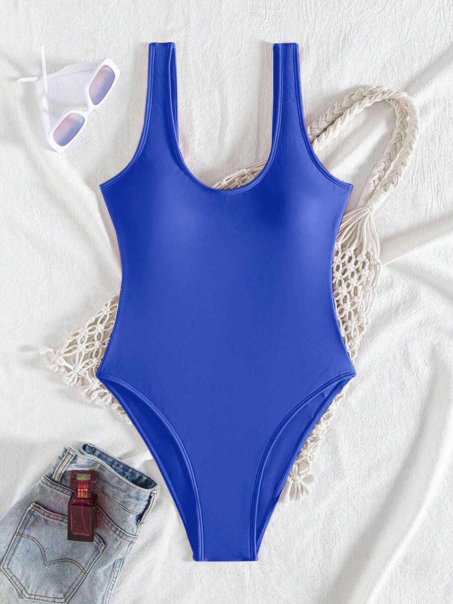 Women's solid color one-piece swimsuit featuring a backless scoop neck design and high cut fit