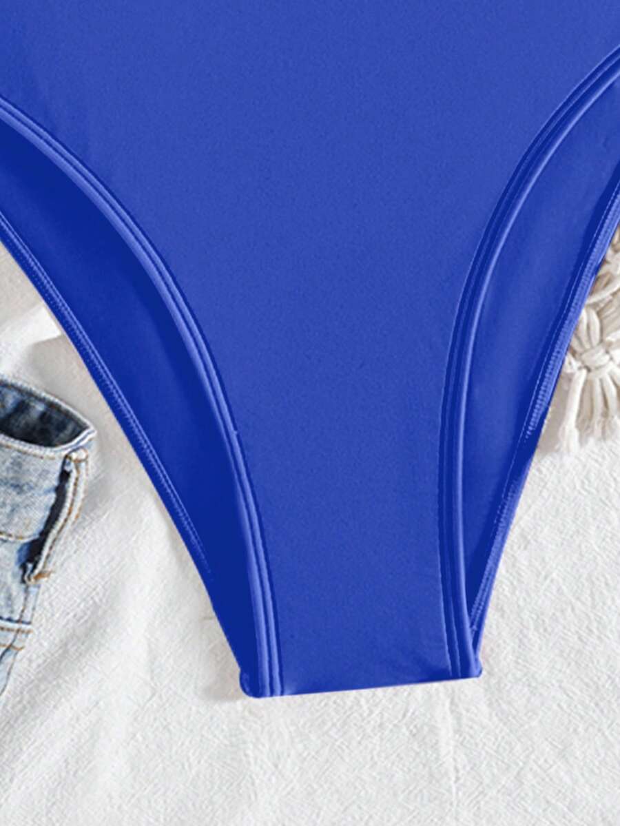 Women's solid color one-piece swimsuit featuring a backless scoop neck design and high cut fit