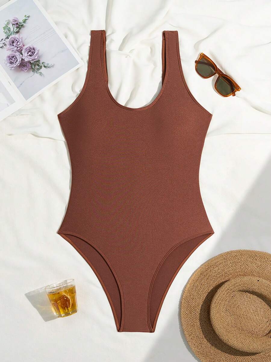 Women's solid color one-piece swimsuit featuring a backless scoop neck design and high cut fit