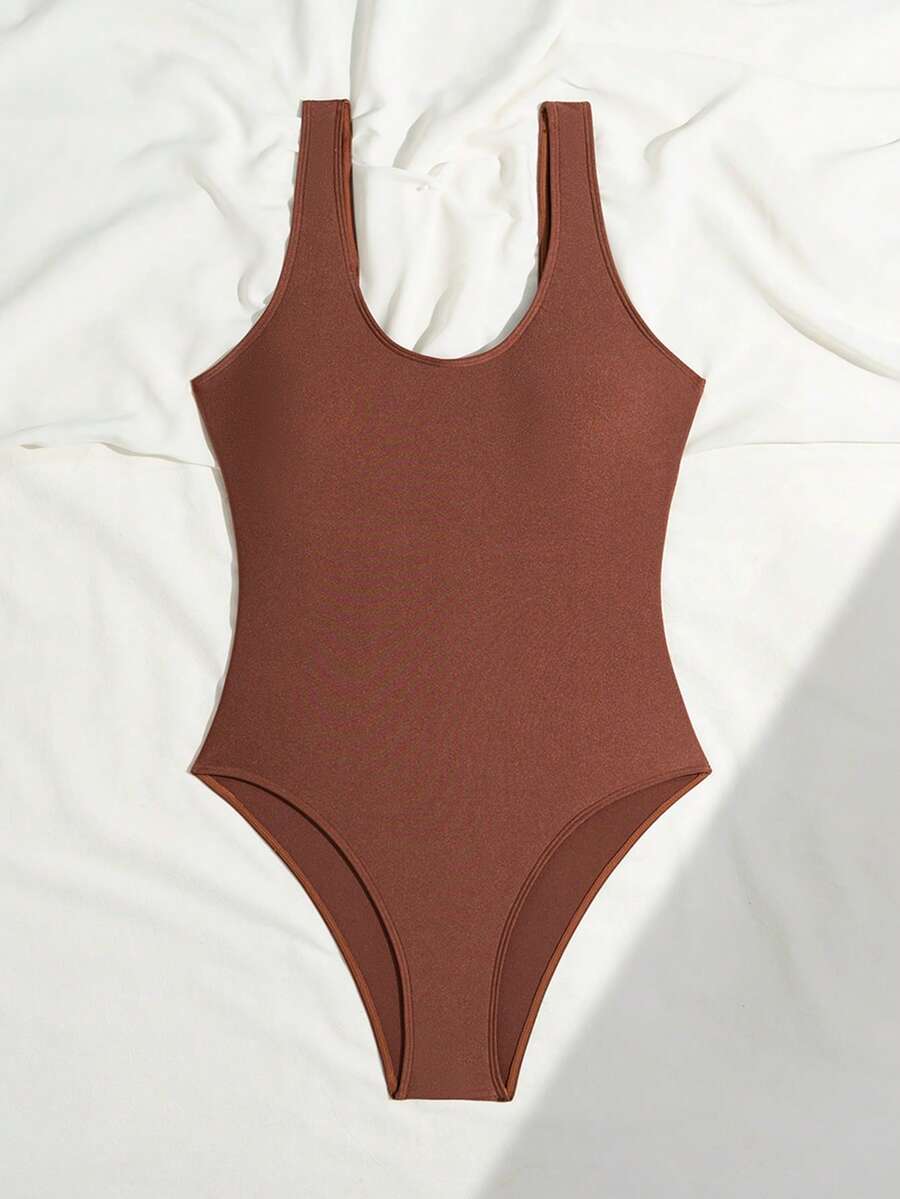 Women's solid color one-piece swimsuit featuring a backless scoop neck design and high cut fit