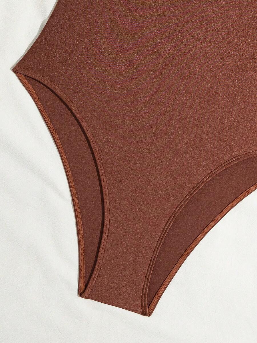 Women's solid color one-piece swimsuit featuring a backless scoop neck design and high cut fit