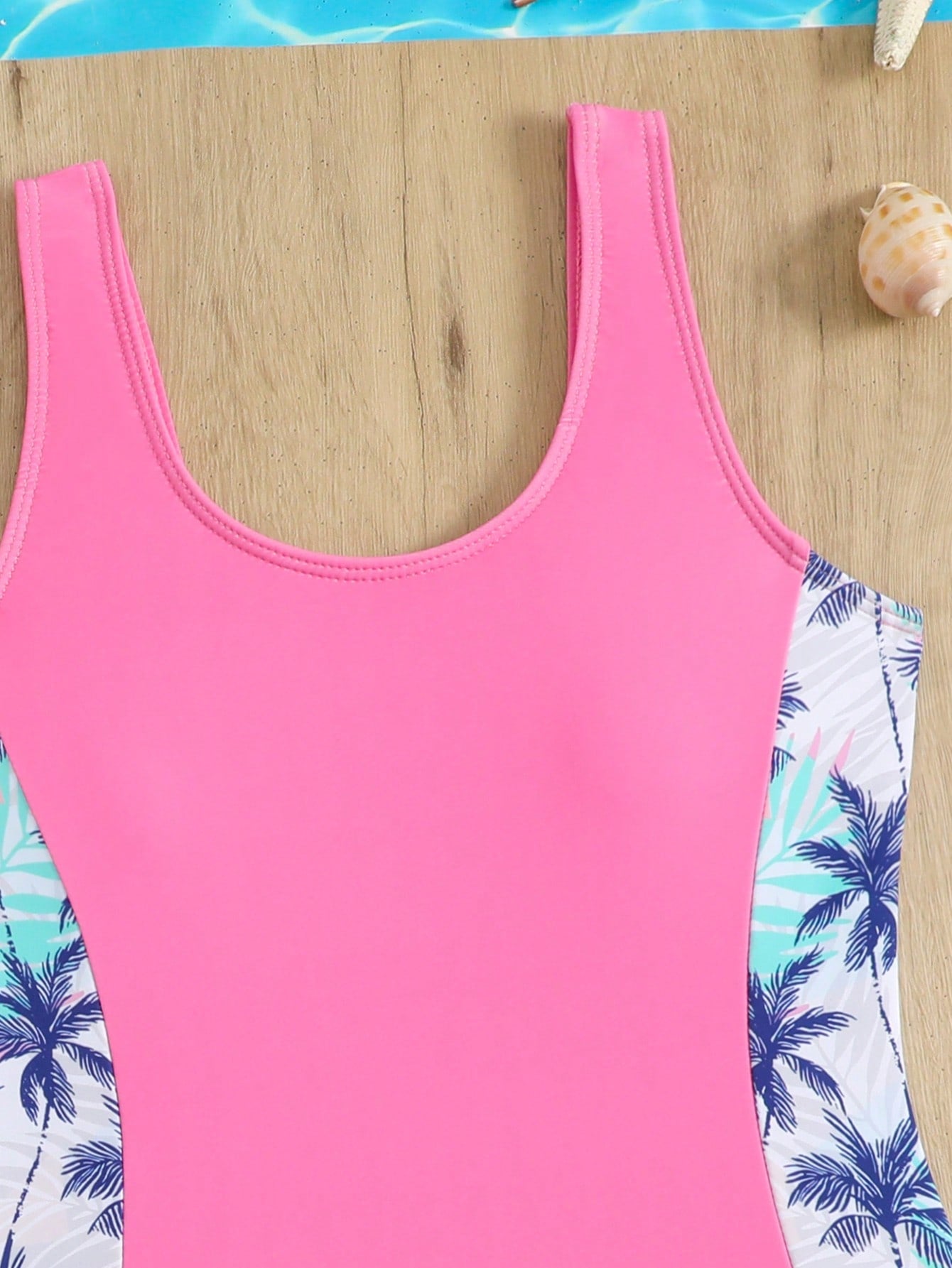Tween girls 2-piece swimsuit set in black with full floral and plant print, featuring a sleeveless scoop-neck swim top and matching shorts-style bottoms.