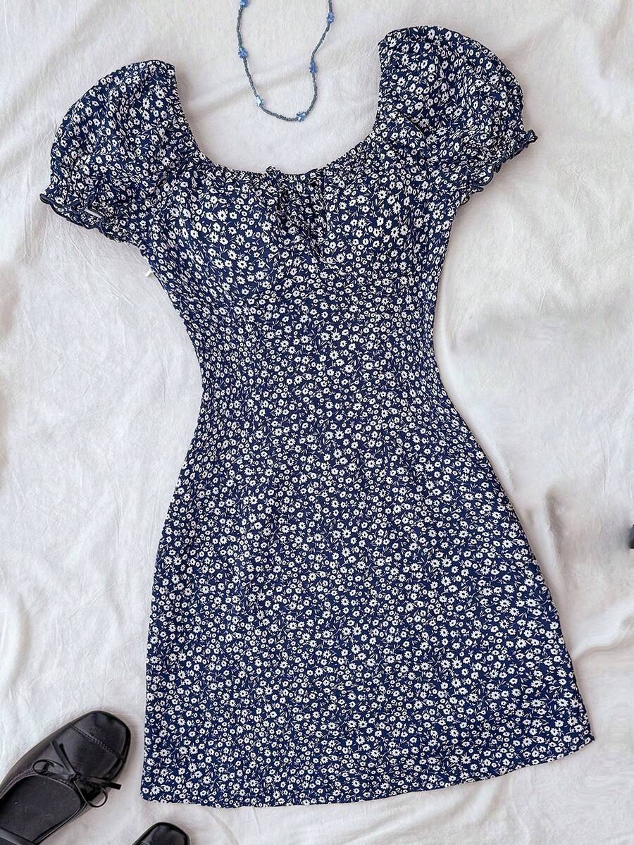 Black floral all-over print midi dress for tween girls featuring puff half sleeves, spaghetti strap neckline, and an A-line silhouette.
