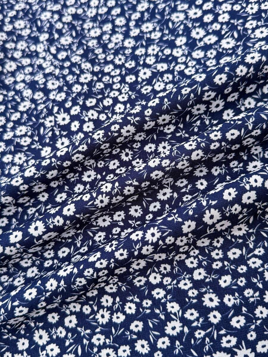Black floral all-over print midi dress for tween girls featuring puff half sleeves, spaghetti strap neckline, and an A-line silhouette.