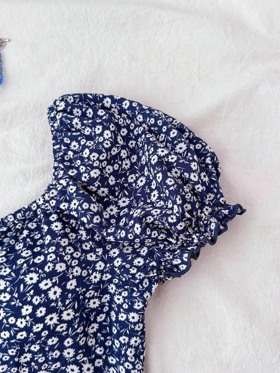 Black floral all-over print midi dress for tween girls featuring puff half sleeves, spaghetti strap neckline, and an A-line silhouette.