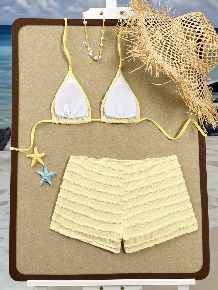 Women's apricot two-piece swimsuit set with a halter tie-back top and matching high stretch shorts.