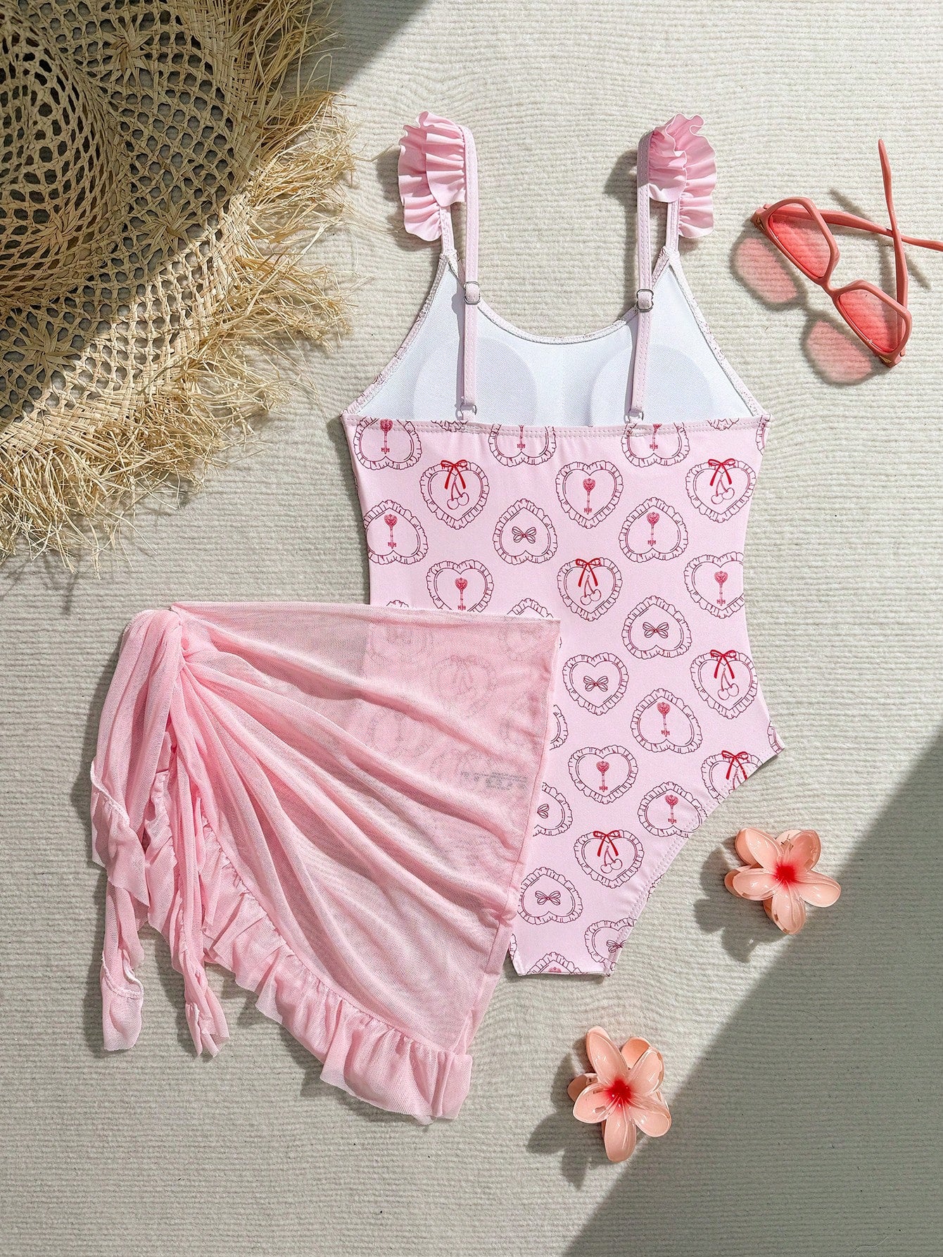 Tween girls one-piece swimsuit in leopard print with ruffle shoulder straps, scoop neckline, fitted shape, and attached ruffle hem skirt; sleeveless, mid-waist skirt bottom, and lined body for swimming, vacation, and summer beach wear.