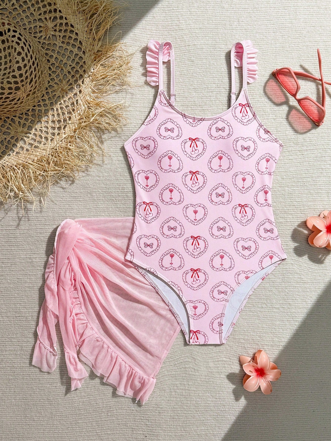 Tween girls one-piece swimsuit in leopard print with ruffle shoulder straps, scoop neckline, fitted shape, and attached ruffle hem skirt; sleeveless, mid-waist skirt bottom, and lined body for swimming, vacation, and summer beach wear.