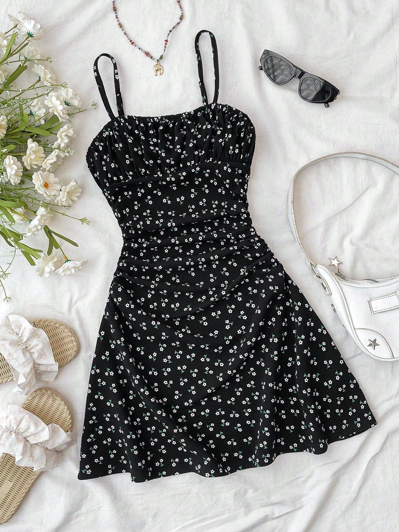 Tween girl yellow mini sundress with large pink floral hibiscus print, spaghetti straps, high waist, flared hem, and sleeveless cami style for summer beach wear