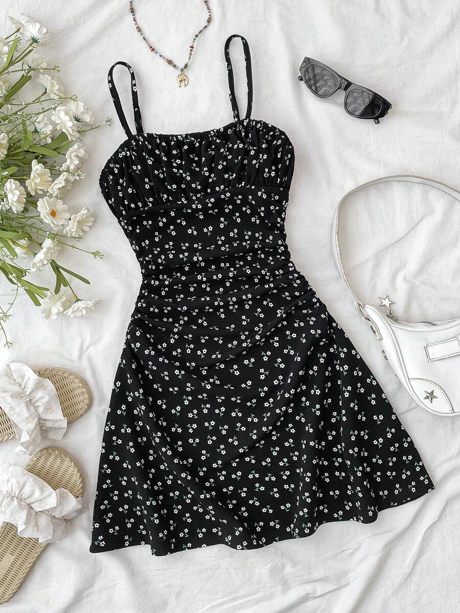 Tween girl yellow mini sundress with large pink floral hibiscus print, spaghetti straps, high waist, flared hem, and sleeveless cami style for summer beach wear