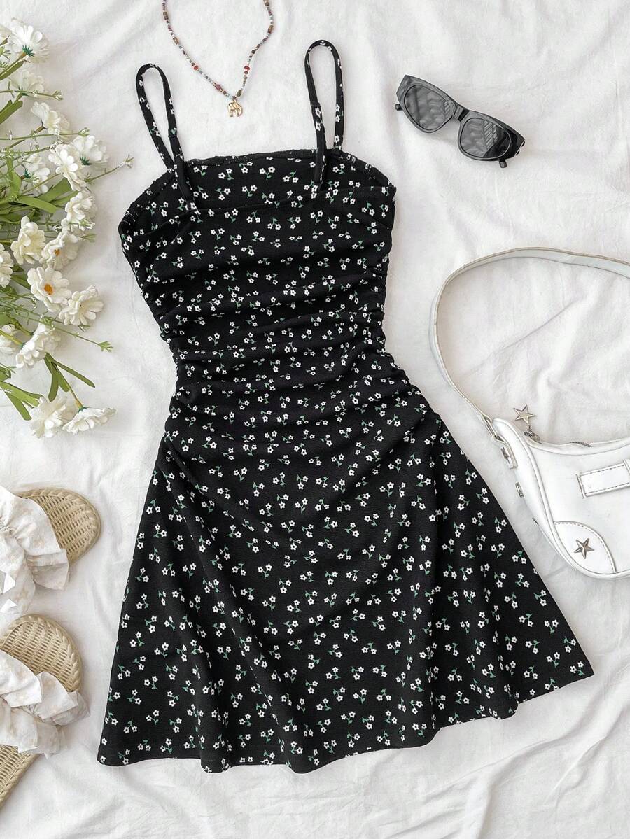 Tween girl yellow mini sundress with large pink floral hibiscus print, spaghetti straps, high waist, flared hem, and sleeveless cami style for summer beach wear