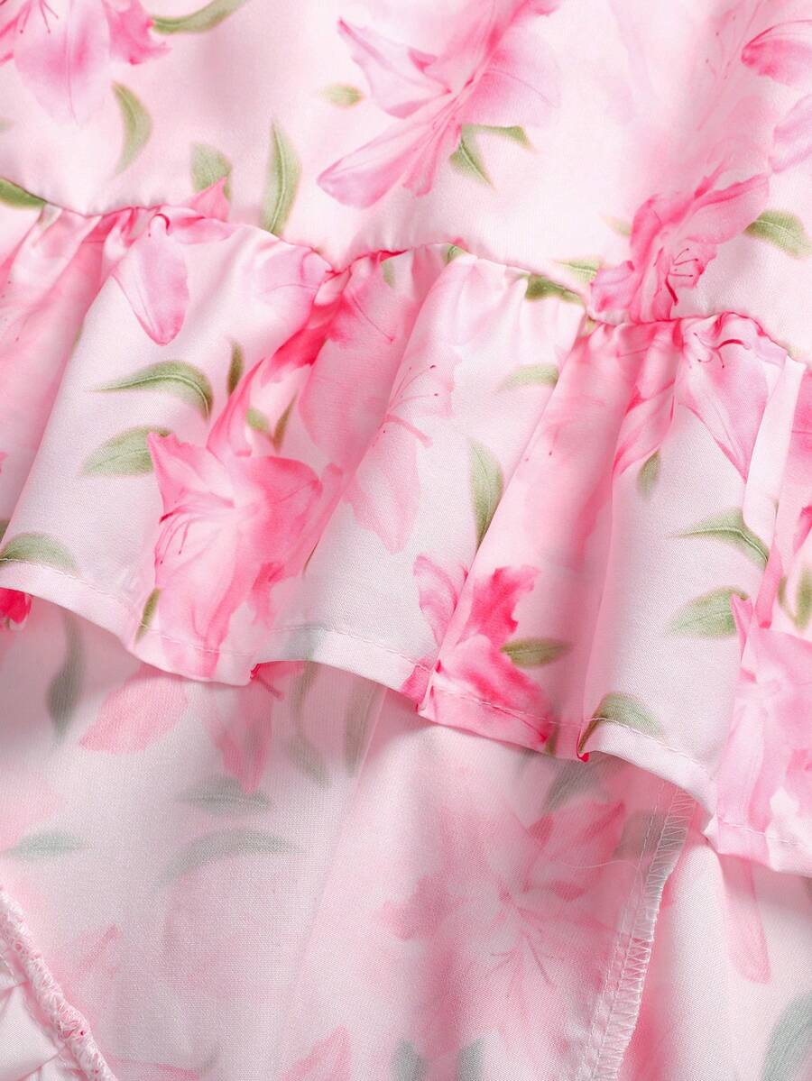 Pink floral print asymmetrical cami dress for tween girls featuring a high waist, sleeveless design, halter neckline, and back zipper.