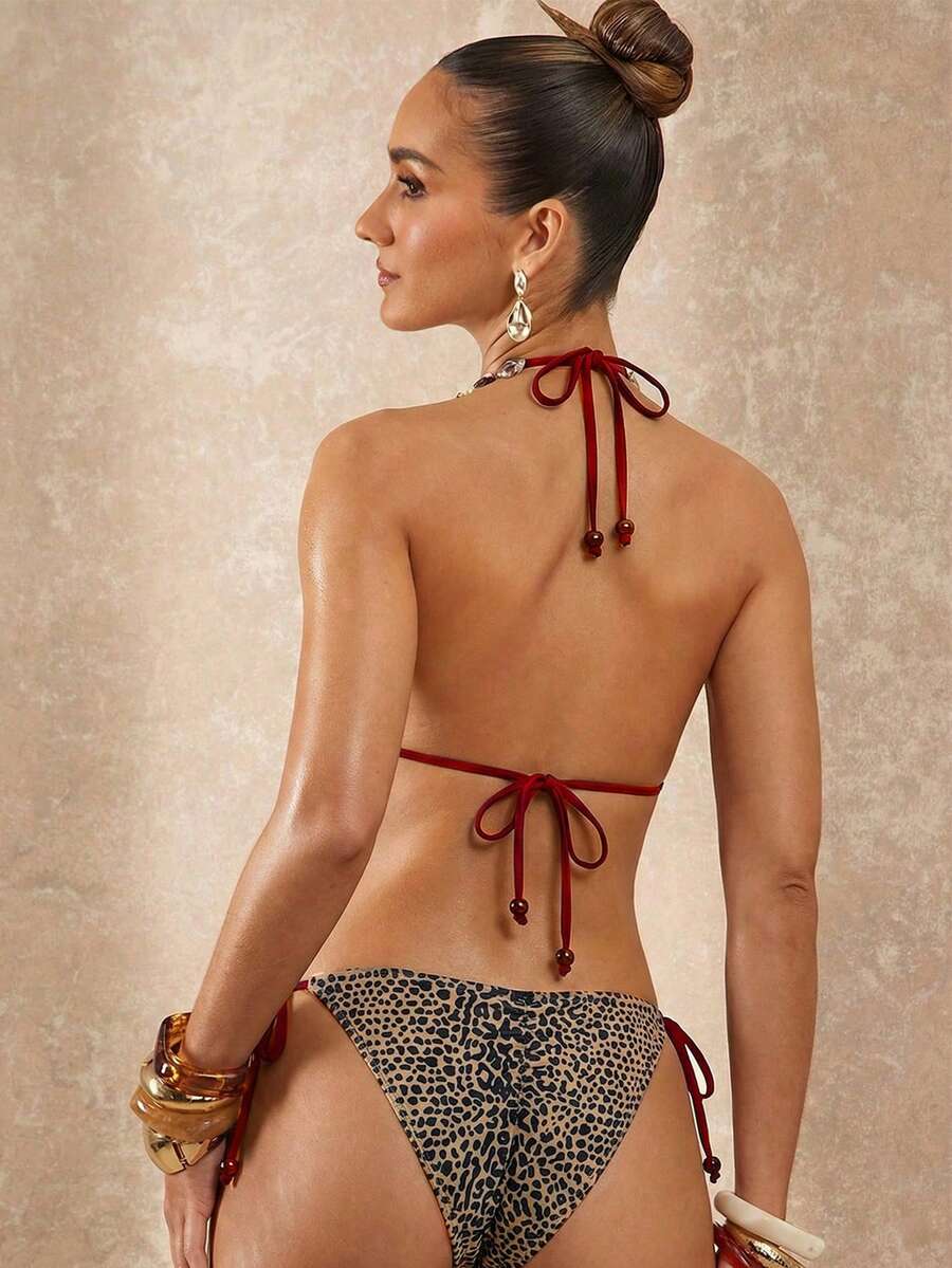 Women's black and white halter triangle bikini top and high waist tie side thong bottoms set.
