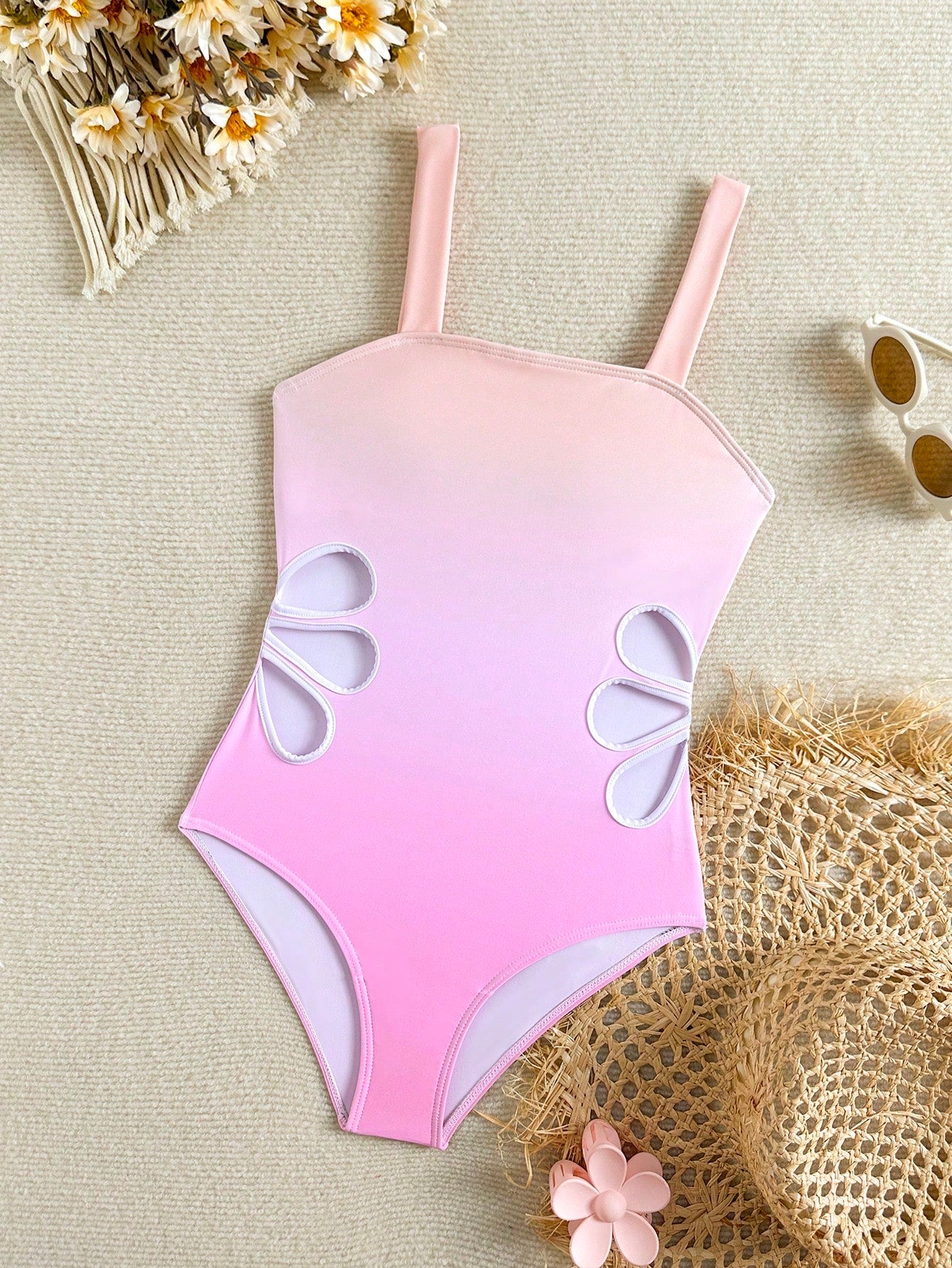Tween girls one-piece swimsuit with a floral plant print, spaghetti straps, and a mid-waist fit in black.