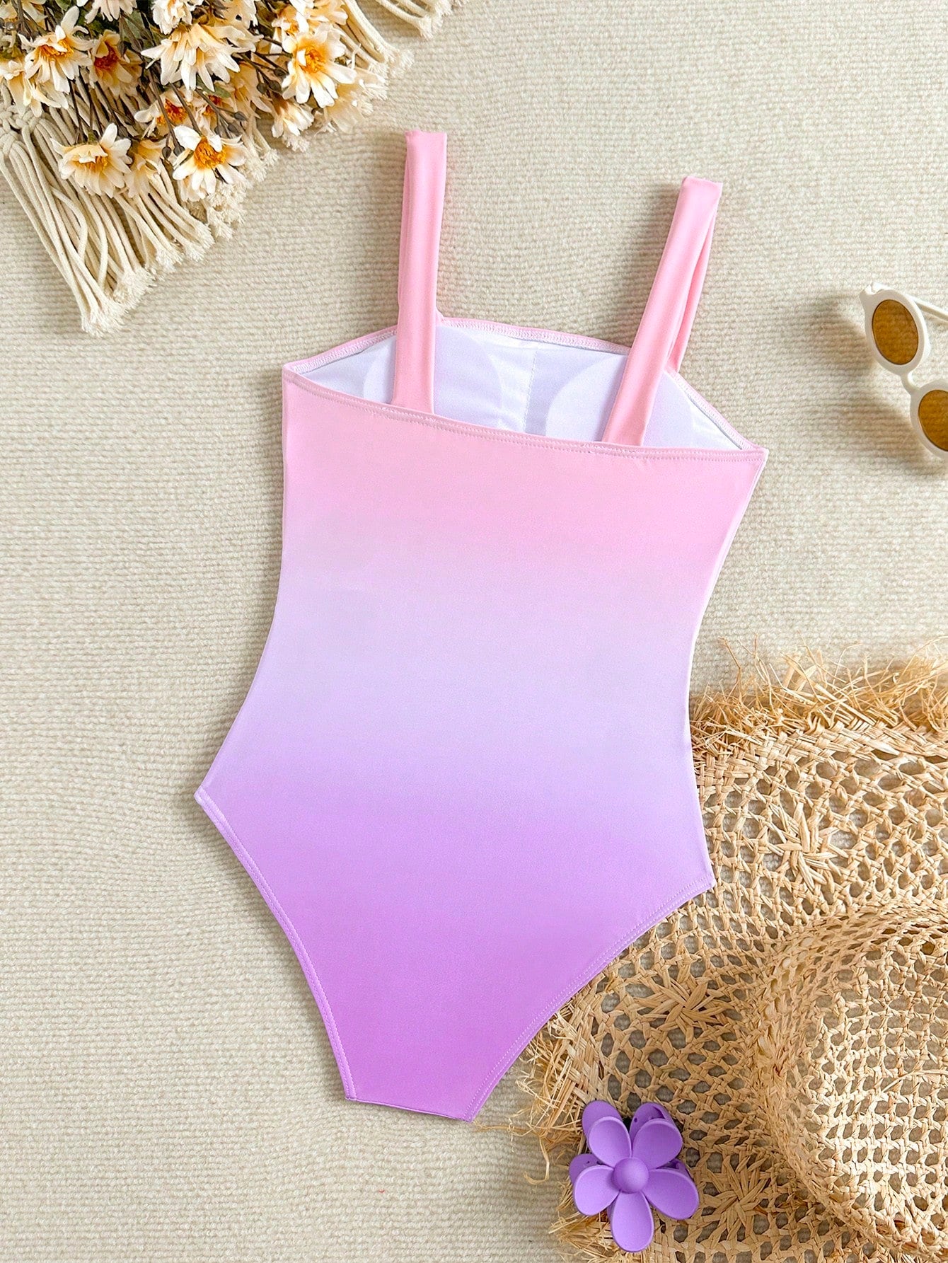 Tween girls one-piece swimsuit with a floral plant print, spaghetti straps, and a mid-waist fit in black.