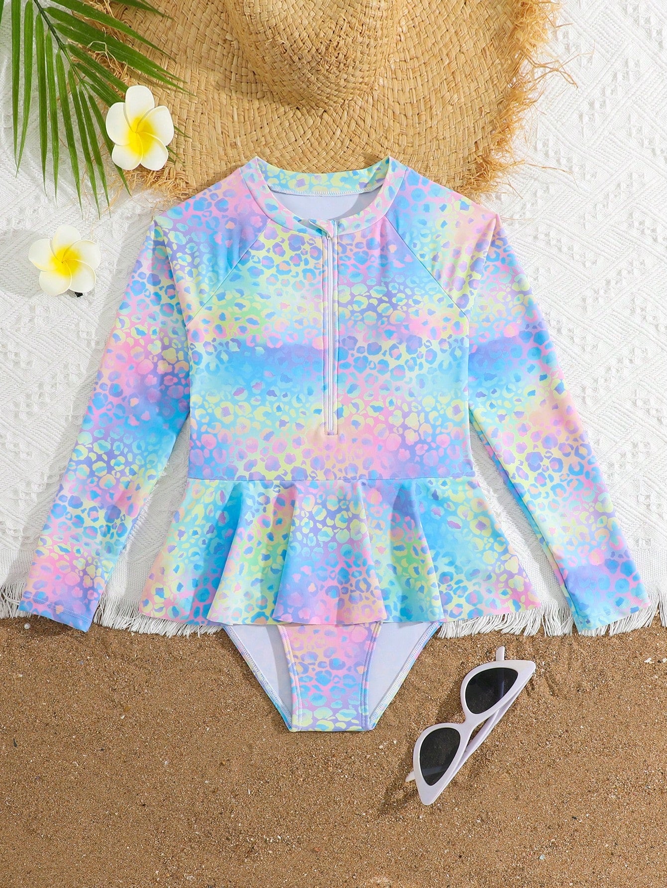 Purple tween girls one-piece swimsuit with graphic striped print, ruffle detail, round neck, and zipper closure for swimming and vacation wear