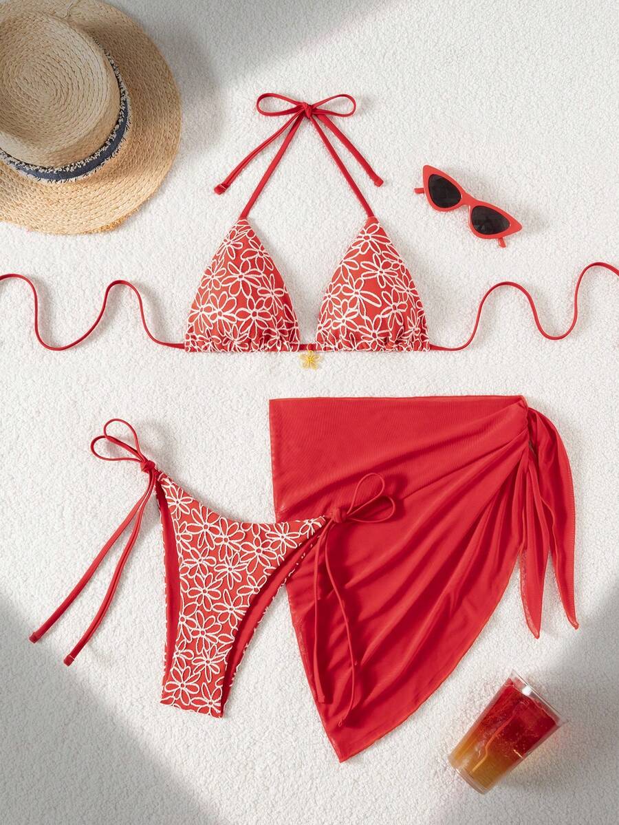 Women's 3-piece blue tropical shell print bikini set featuring a halter bralette top, low-waist tie-side bottom, and a matching sheer mesh cover-up skirt.