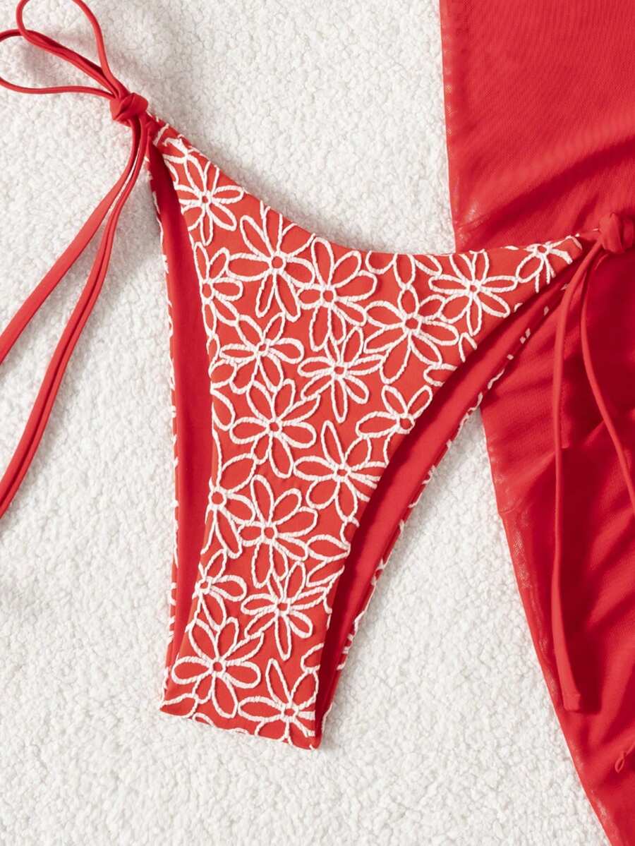 Women's 3-piece blue tropical shell print bikini set featuring a halter bralette top, low-waist tie-side bottom, and a matching sheer mesh cover-up skirt.