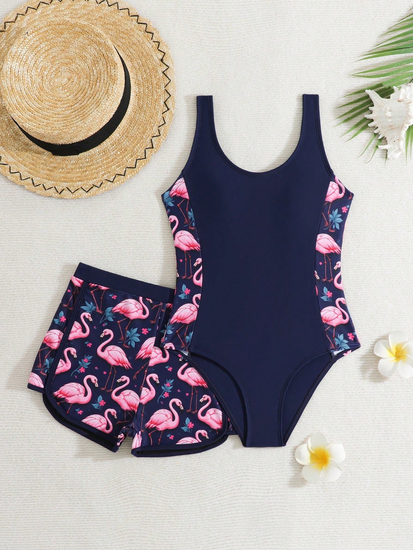 Tween girls 2-piece swimsuit set with a printed one-piece featuring ruffle trim, scoop neckline, cut-out detail, and matching shorts bottom.