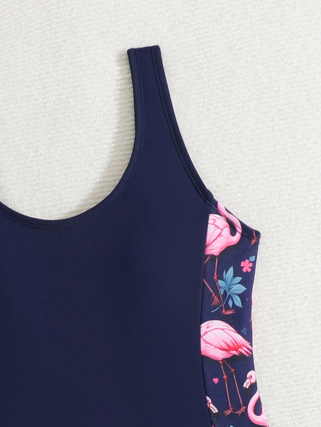 Tween girls 2-piece swimsuit set with a printed one-piece featuring ruffle trim, scoop neckline, cut-out detail, and matching shorts bottom.