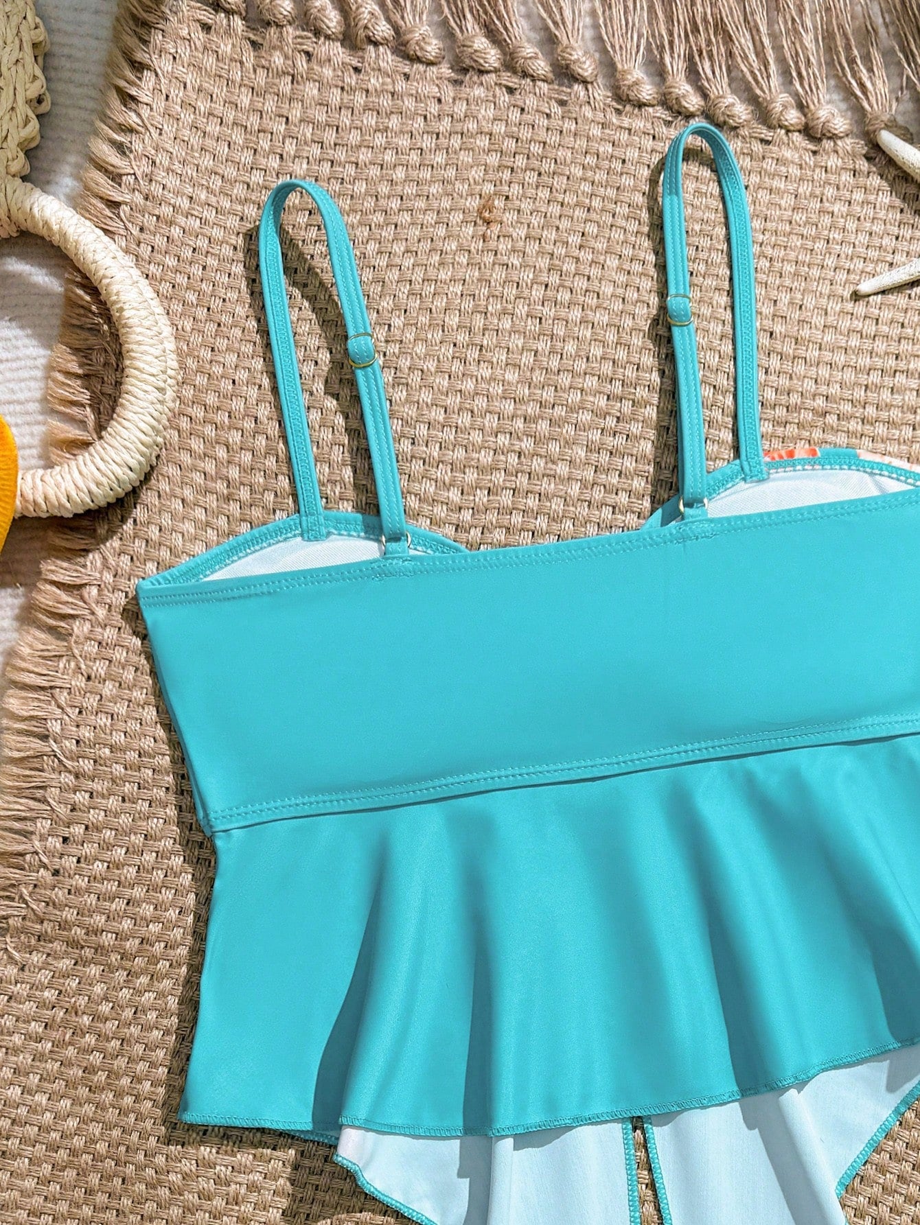 Tween girls two-piece tankini swimwear set with spaghetti straps, asymmetrical design, and 3D rose detail. Features a plant-pattern top and mid-waist bottoms in stretchy fabric for beach or pool wear.