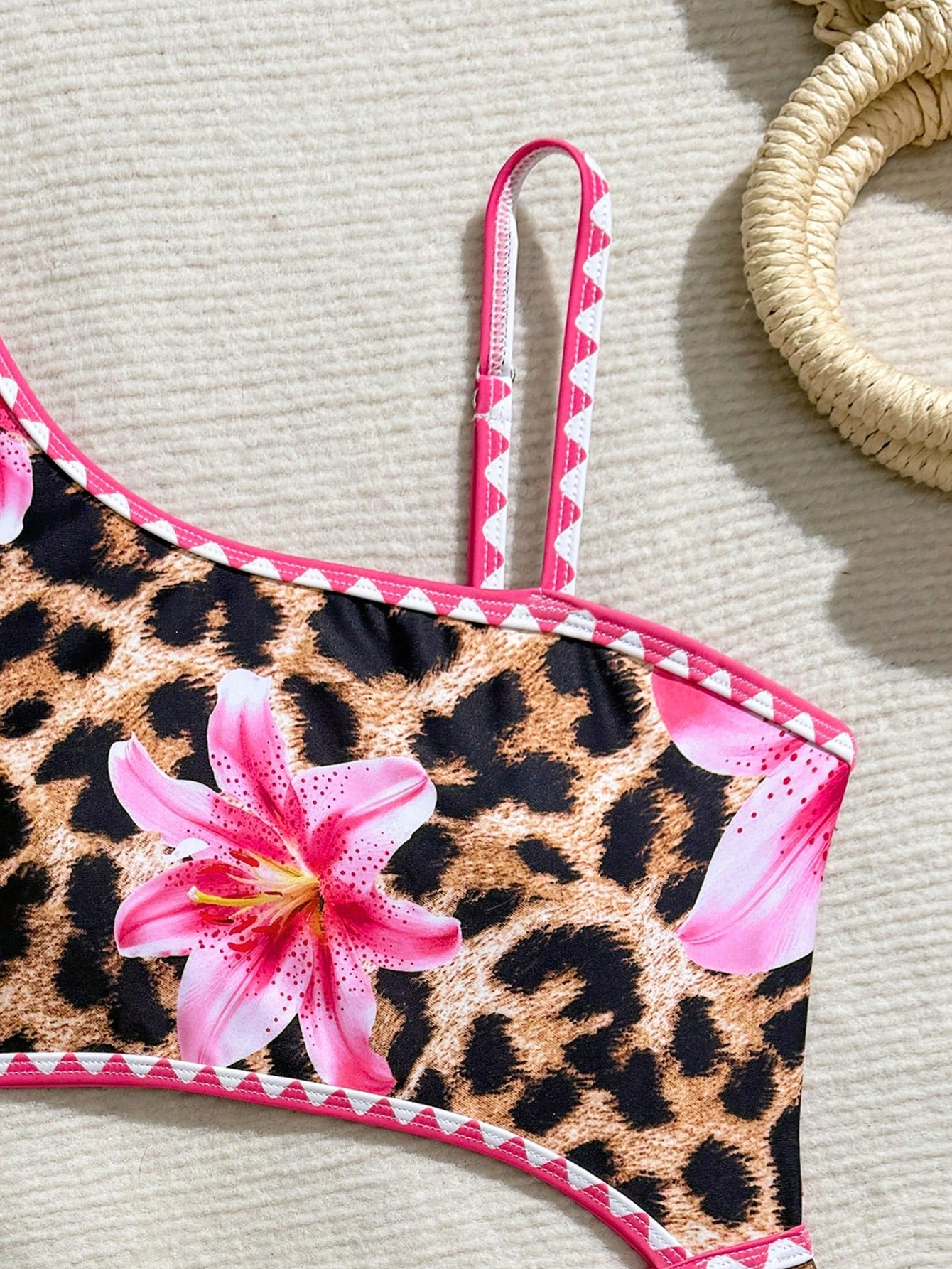 Tween girls one-piece swimsuit featuring an asymmetric neckline, pendant decor, plain design, wireless bra, high-cut bottom, and medium-stretch fabric.