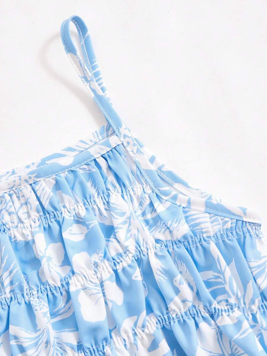 Tween girls light blue 2-piece summer vacation outfit featuring a plant print spaghetti strap camisole top with shirred ruffle hem and wide-leg long pants.