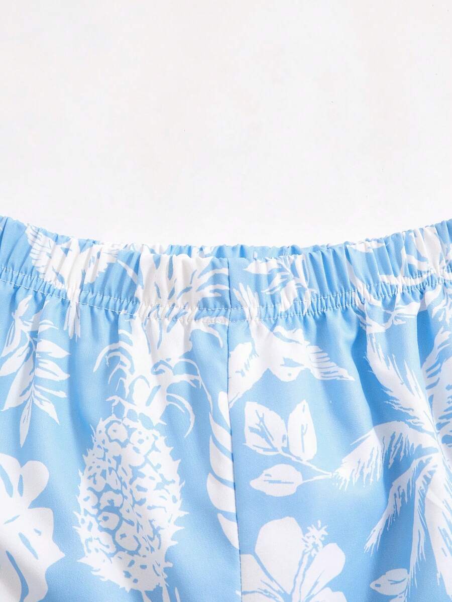 Tween girls light blue 2-piece summer vacation outfit featuring a plant print spaghetti strap camisole top with shirred ruffle hem and wide-leg long pants.