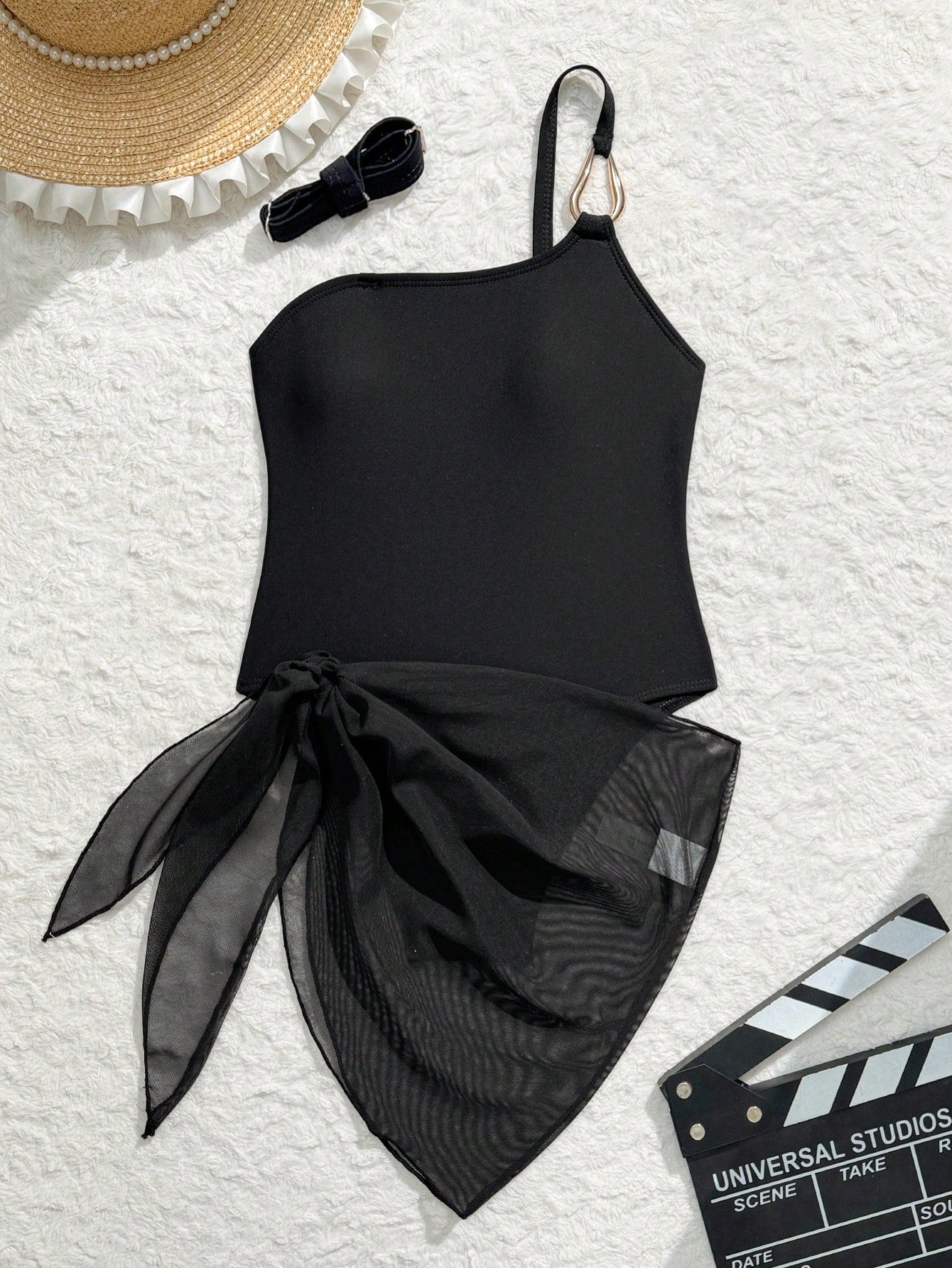 Black girls' one-piece swimsuit with spaghetti straps, plain design, and short asymmetrical mesh ruffle skirt for beach or vacation wear
