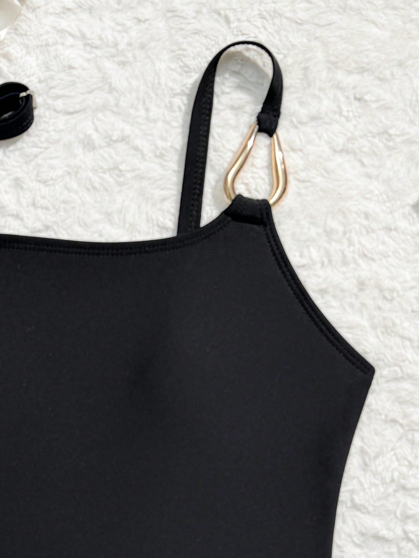 Black girls' one-piece swimsuit with spaghetti straps, plain design, and short asymmetrical mesh ruffle skirt for beach or vacation wear